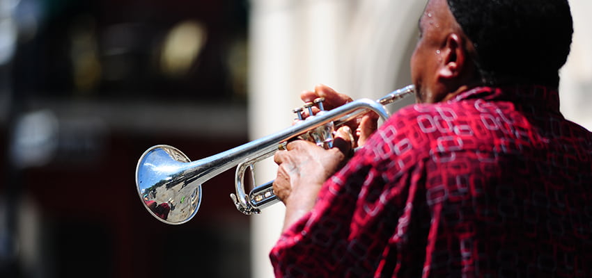 A trumpet player busks on a New Orleans street