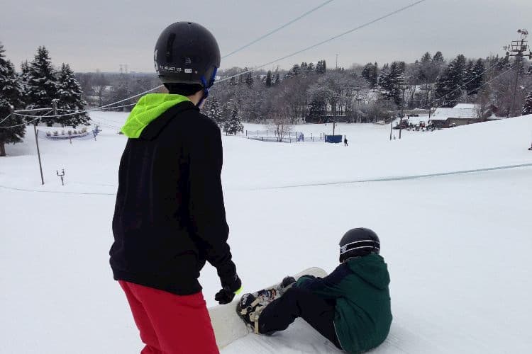 Two boys snowboarding at Villa Olivia