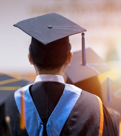 Student wearing graduation robes and a cap