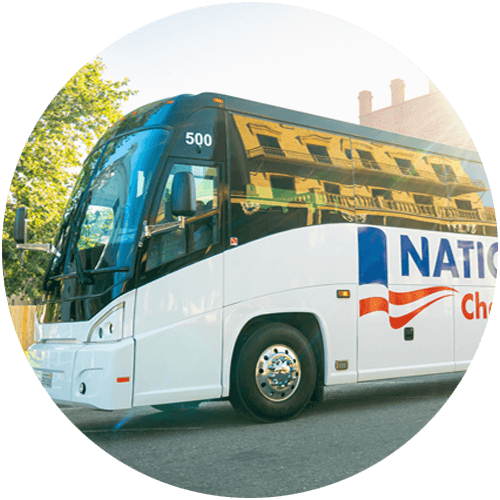 A white charter bus on a city street