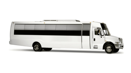 a long, white 25-passenger minibus