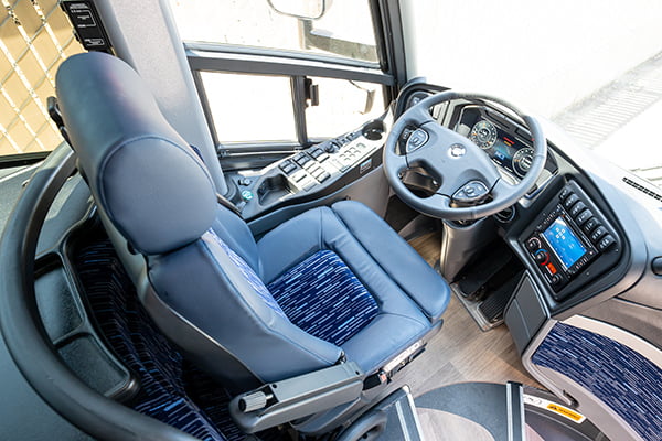 the vacant driver seat of a charter bus