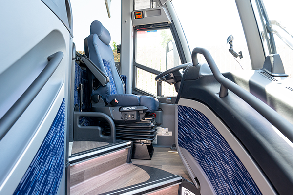 a professional charter bus driver's seat and steering wheel