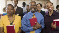 a group of people holding bibles in a church