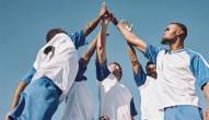 teammates high five in a circle