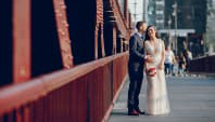 a couple taking wedding photos in the city