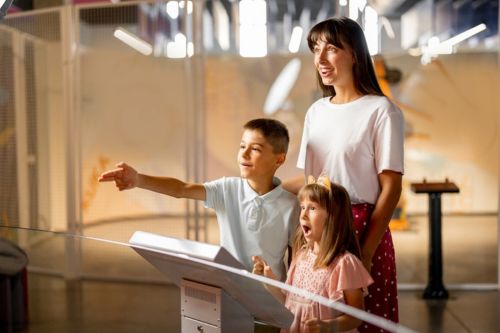 A family looking at an exhibit at a science museum